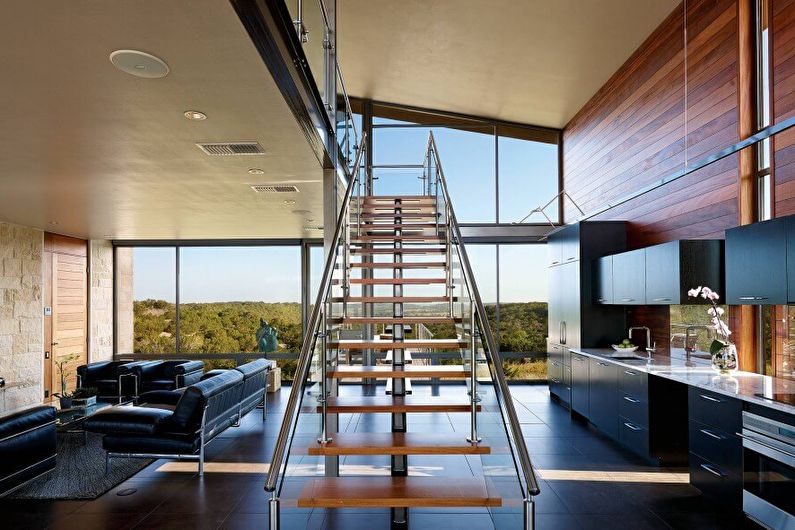 a modern living room with a wooden staircase.