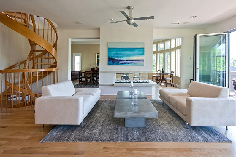 a living room with a spiral staircase.