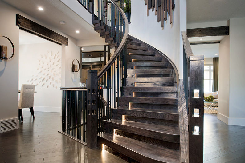 a spiral staircase in a home with hardwood floors.