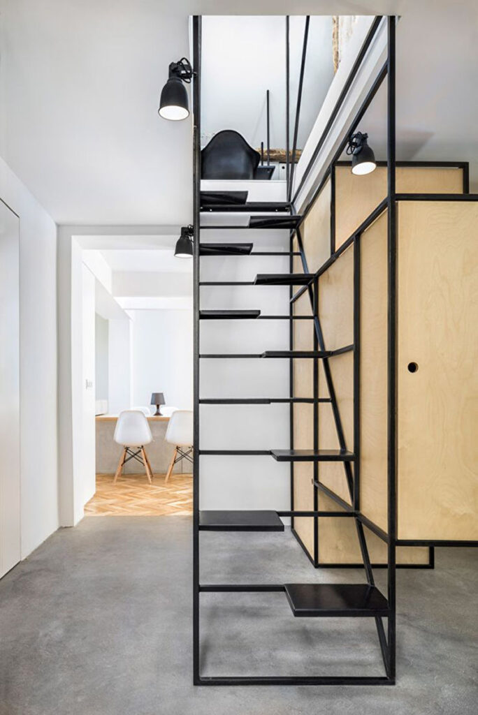 a black staircase in a room with white walls.