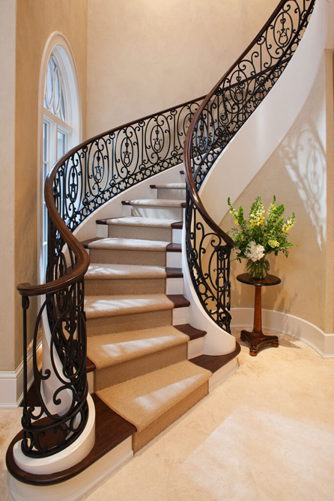 a staircase with wrought iron railings.