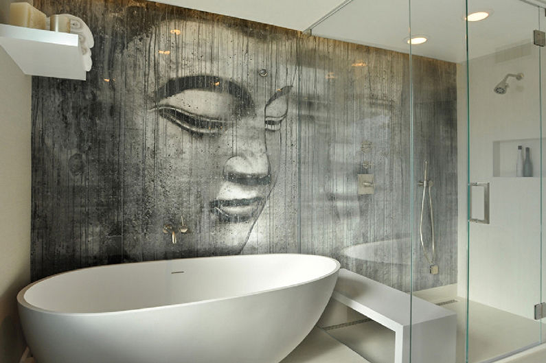 a bathroom with a buddha head on the wall.