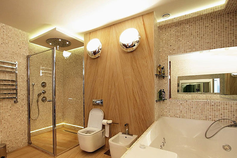 a bathroom with a toilet, shower, and sink.