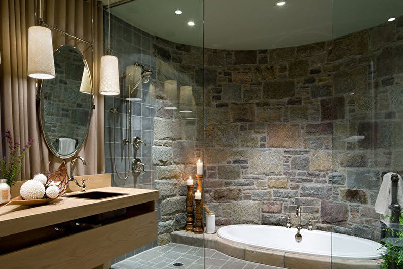 a bathroom with stone walls and a large tub.