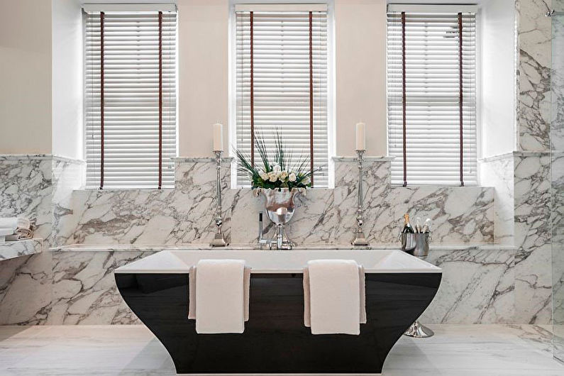 a bathroom with marble walls and a bathtub.