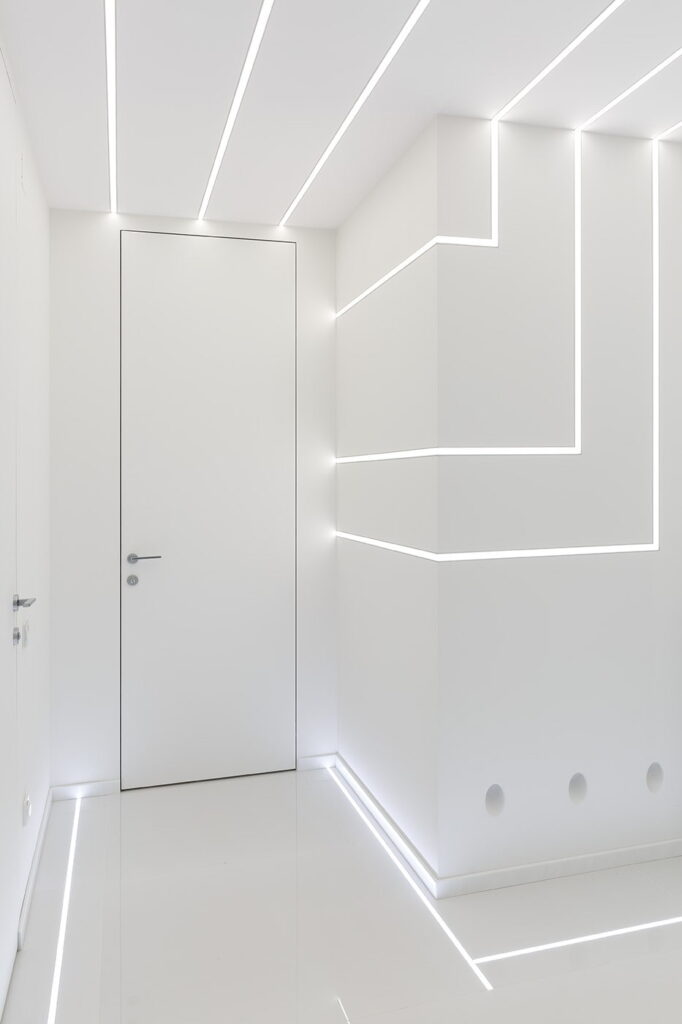 a room with white walls and a door with light lines.