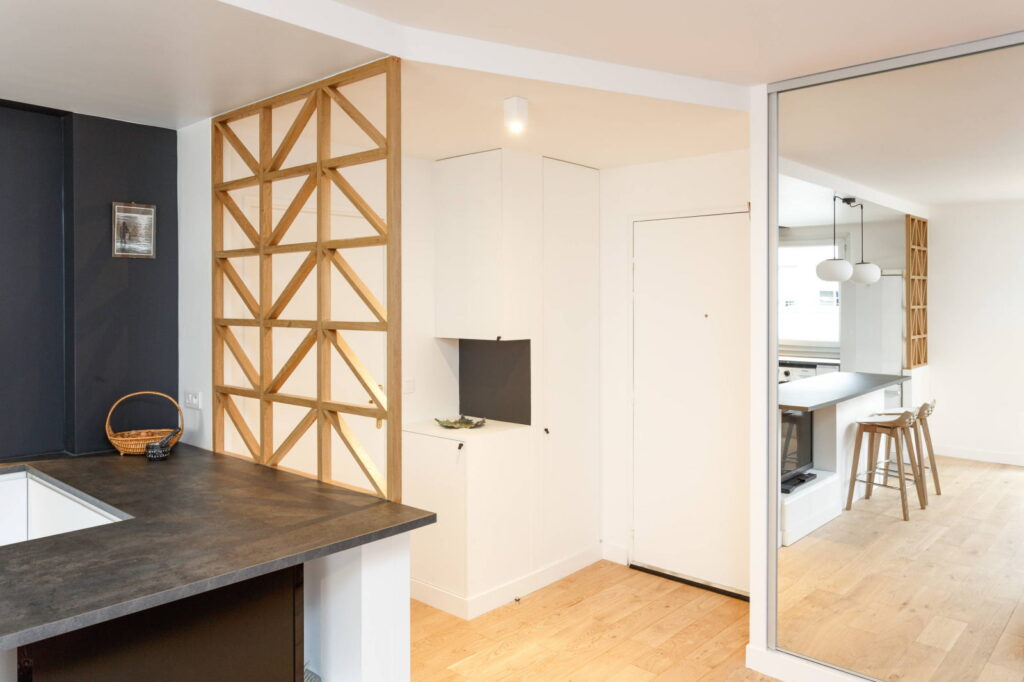 a kitchen with wooden cabinets and a mirror.