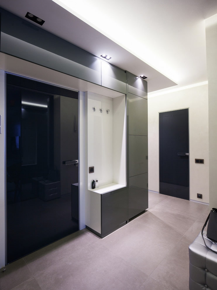 a black and white bathroom with a sink and mirror.