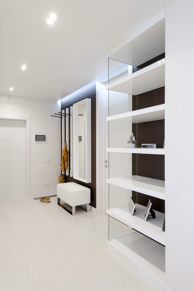 a white living room with shelves and a mirror.