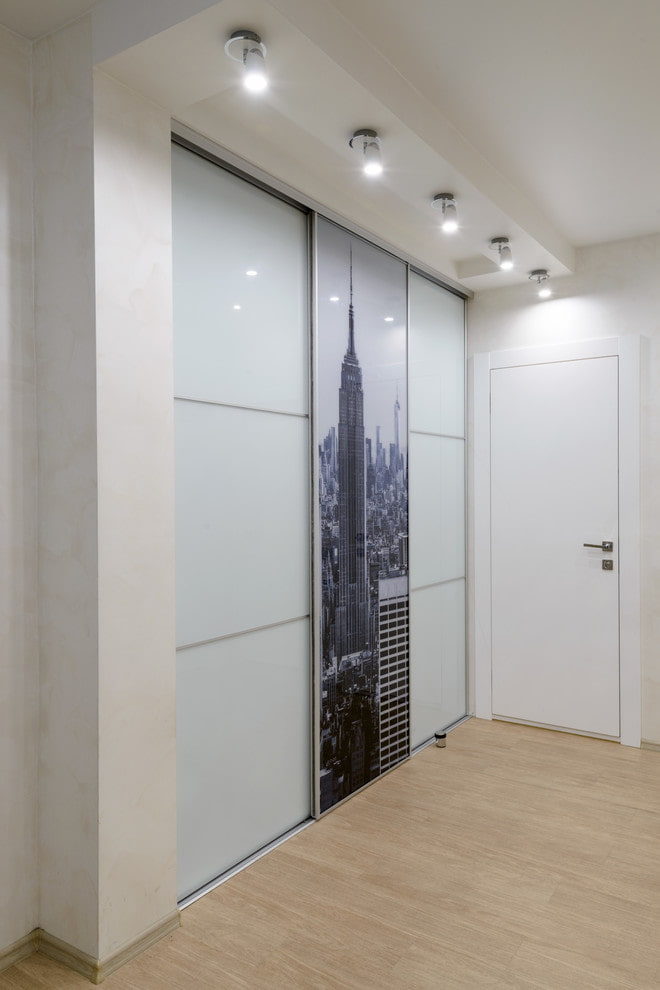 a room with sliding glass doors and a picture of the empire state building.