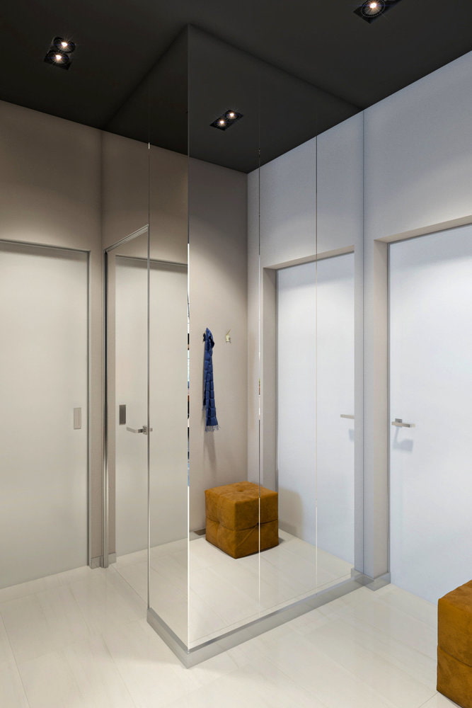 a bathroom with a glass shower door and a wooden bench.