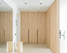 an empty room with wooden walls and a mirror.