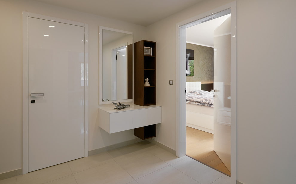 a white bathroom with a sink and mirror.