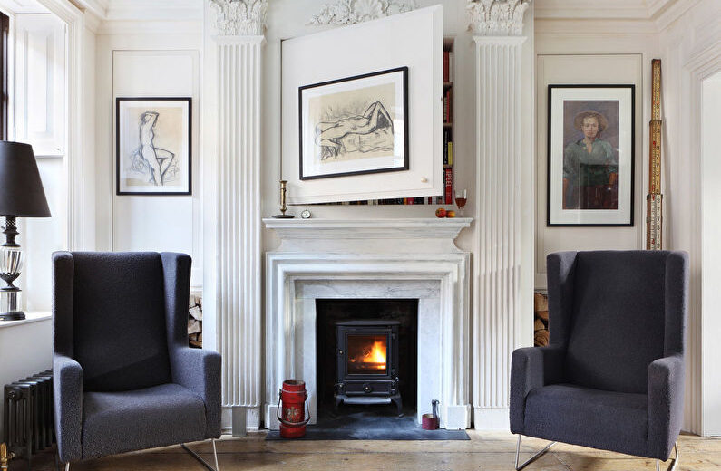 a living room with two chairs and a fireplace.