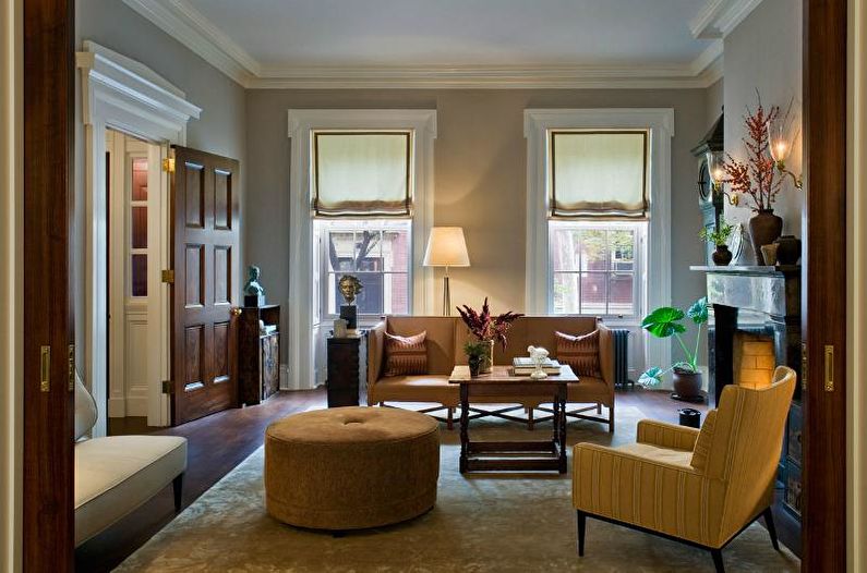 a living room with brown furniture and a fireplace.