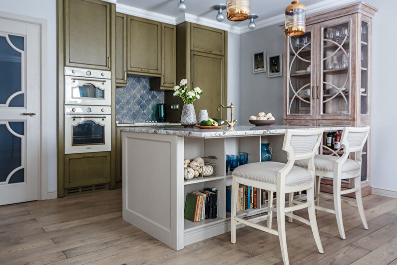 a kitchen with green cabinets and a wooden island.