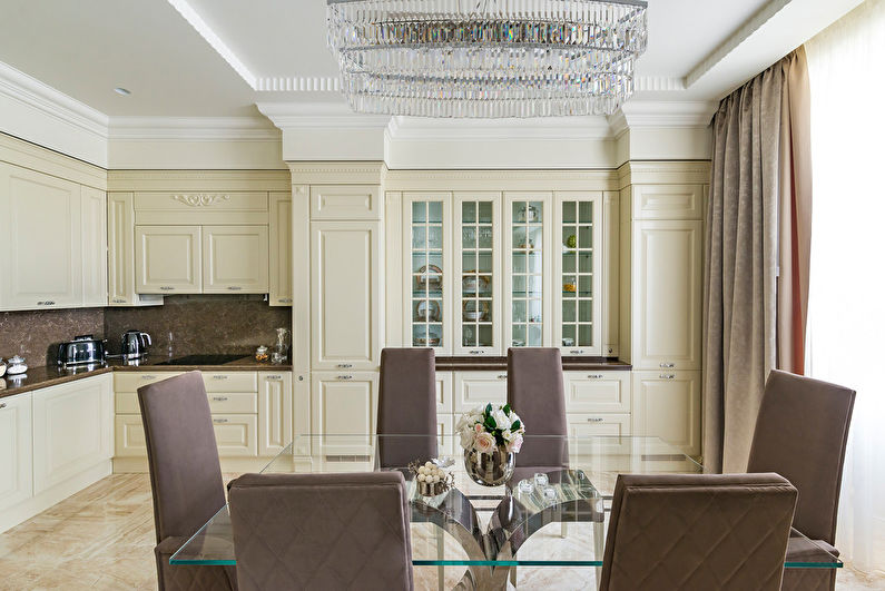 a dining room with a glass table and chairs.