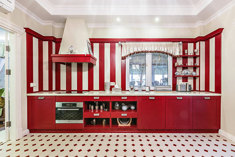 a kitchen with red and white striped cabinets.