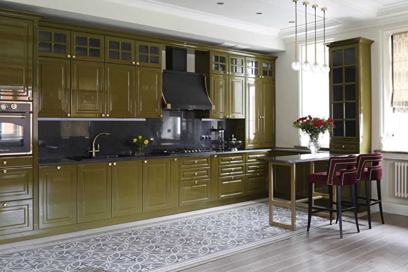 a kitchen with green cabinets and a bar stools.