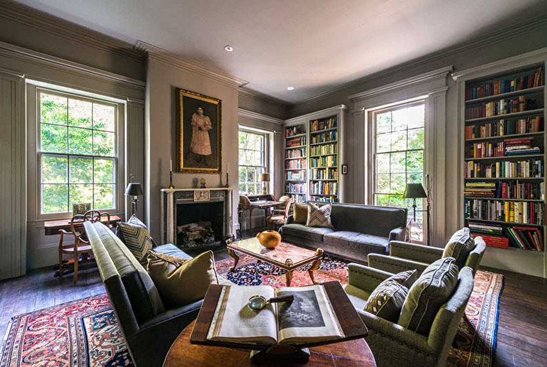 a living room with a fireplace and bookshelves.