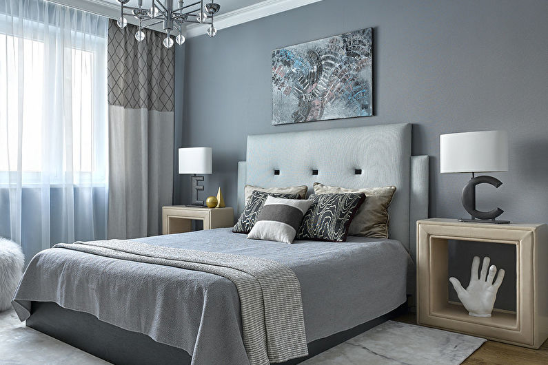 a bedroom with gray walls and a white bed.