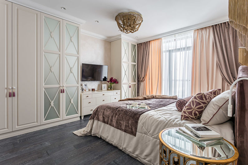 a bedroom with a bed, dresser, and tv.