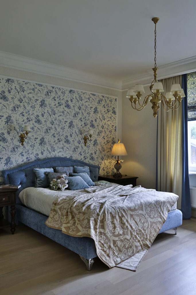 a bedroom with a bed and a chandelier.