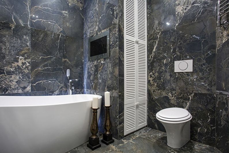 a bathroom with black marble walls and a bathtub.