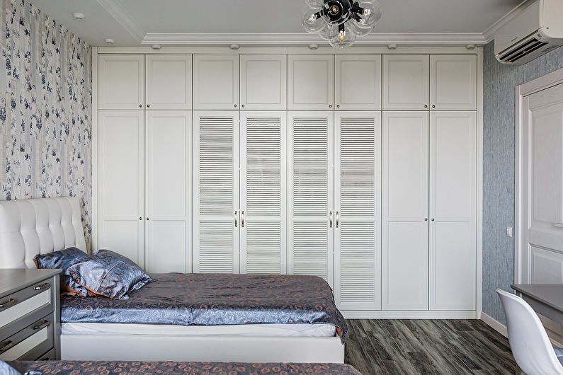 a bedroom with two beds and a desk.