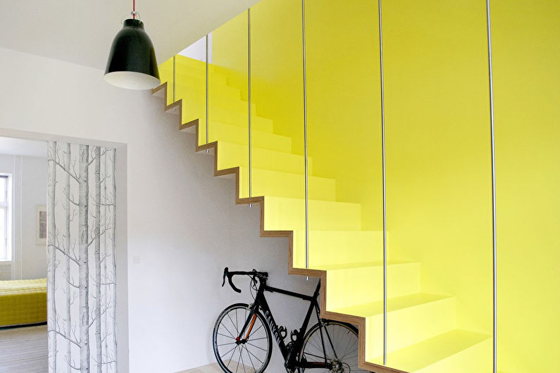 a yellow stairway with a bicycle leaning against it.