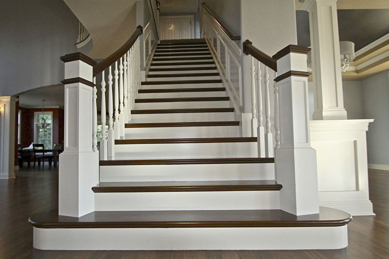 a white staircase with wood treads in a home.