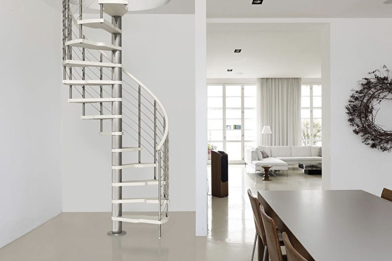 a white spiral staircase in a living room.