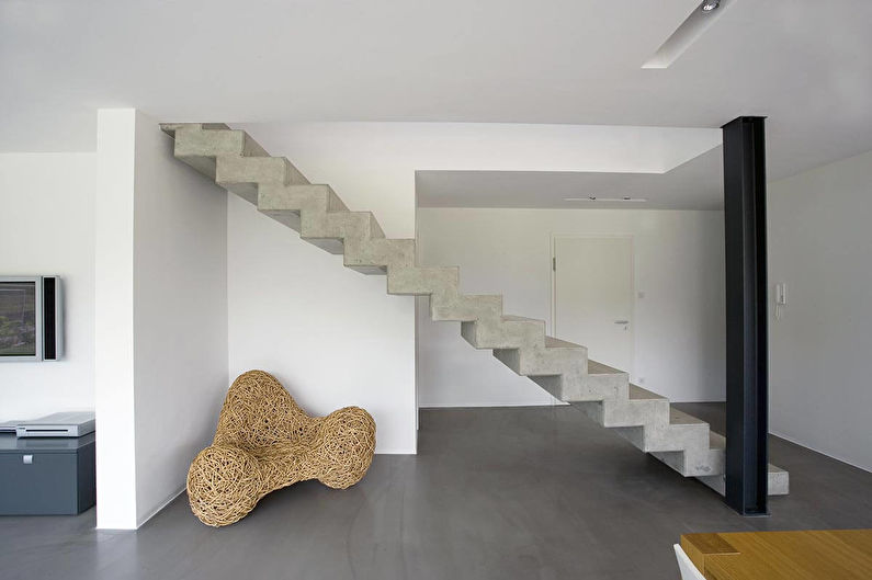 a concrete staircase in a living room.