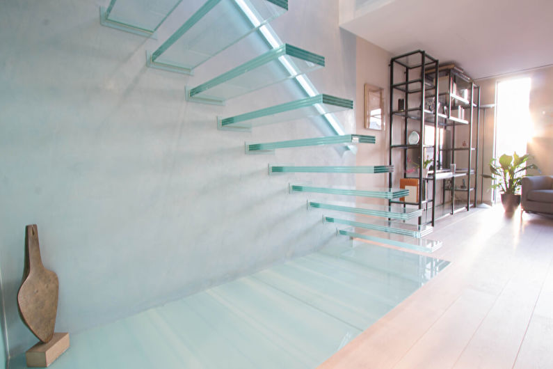 a glass staircase in a living room.