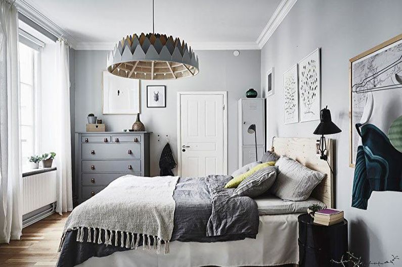 a bedroom with grey walls and wooden floors.