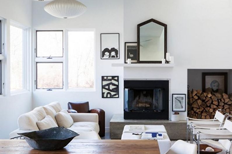 a living room with white furniture and a fireplace.