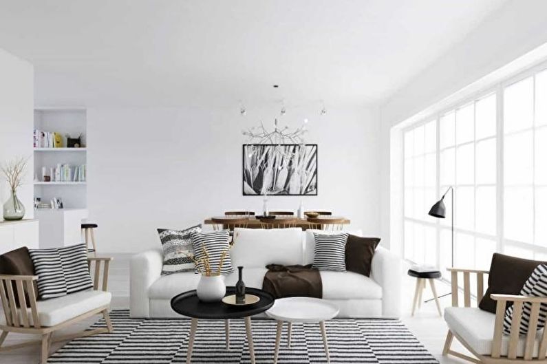 a white living room with black and white striped furniture.