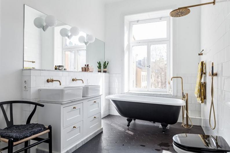 a white and black bathroom with a bathtub.