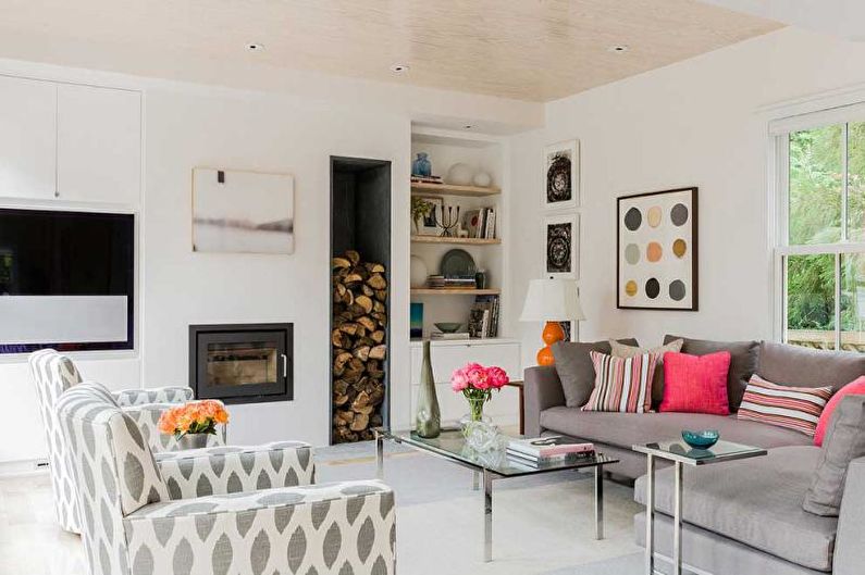 a living room with gray couches and a fireplace.