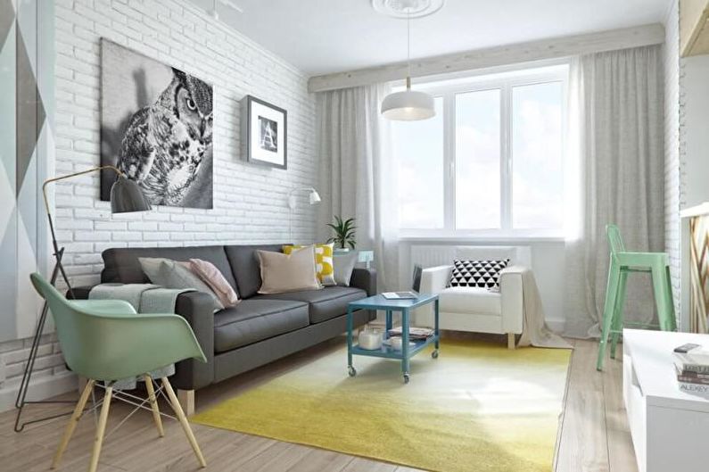 a white and yellow living room with a brick wall.