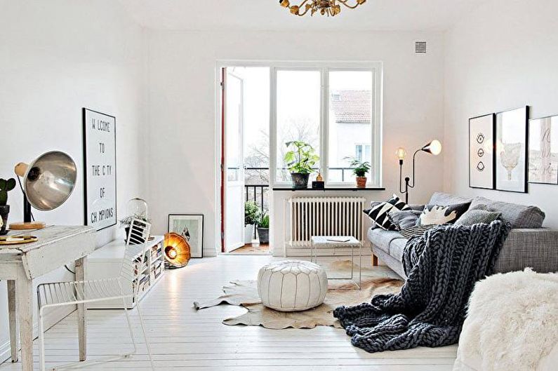 a white living room with a rug and a lamp.