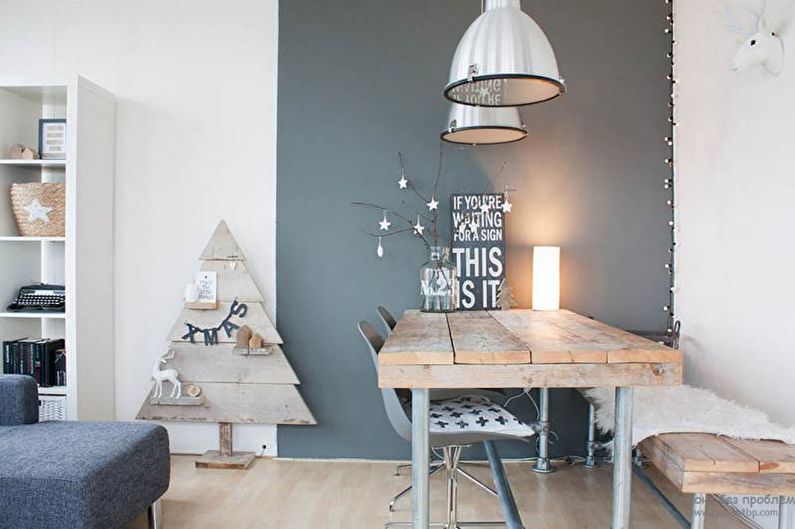 a grey and white dining room with a wooden table and chairs.