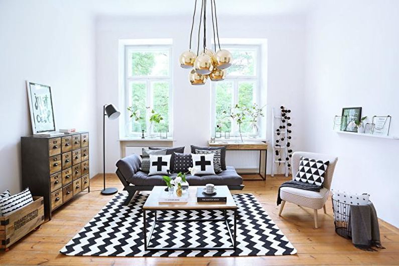 a living room with a black and white rug.