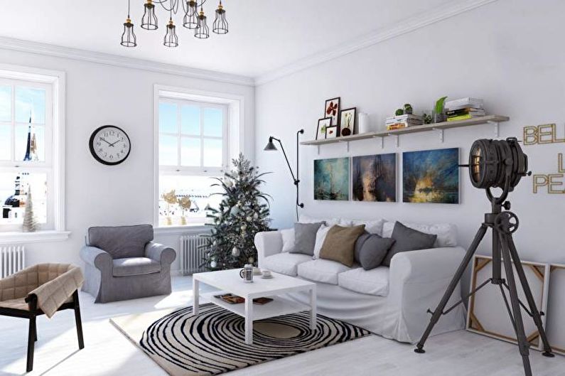 a living room with white furniture and a lamp.