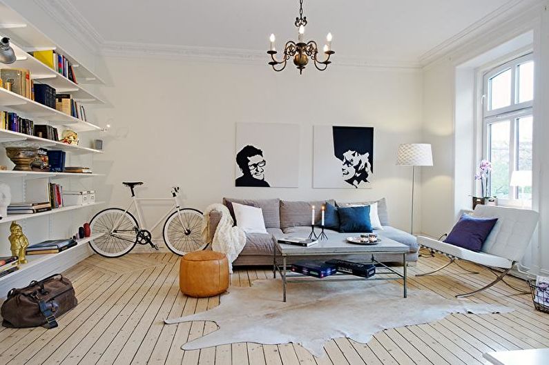 a living room with a white couch and a bicycle.