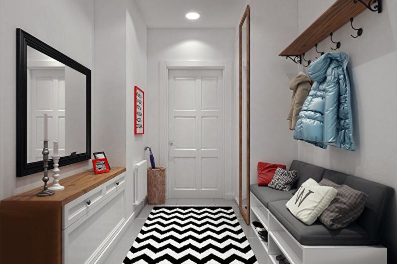 a hallway with a black and white chevron rug.