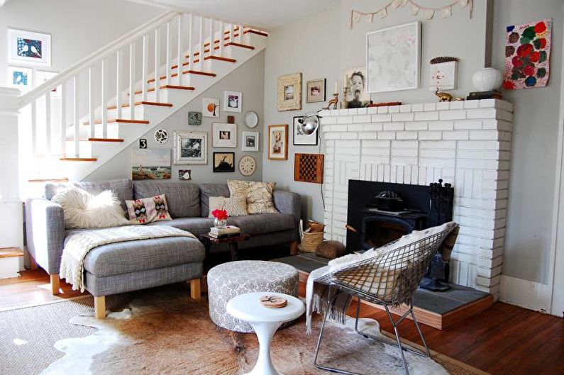 a living room with a fireplace and pictures on the wall.