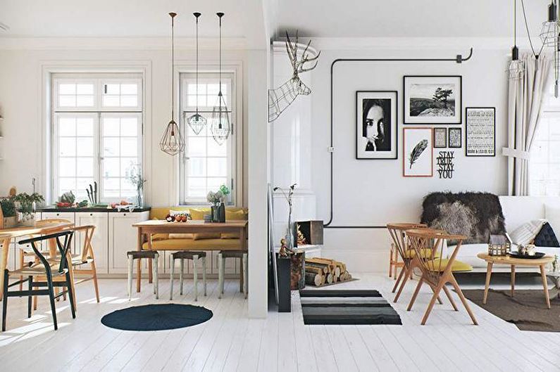 a living room and dining room with white walls and wooden floors.