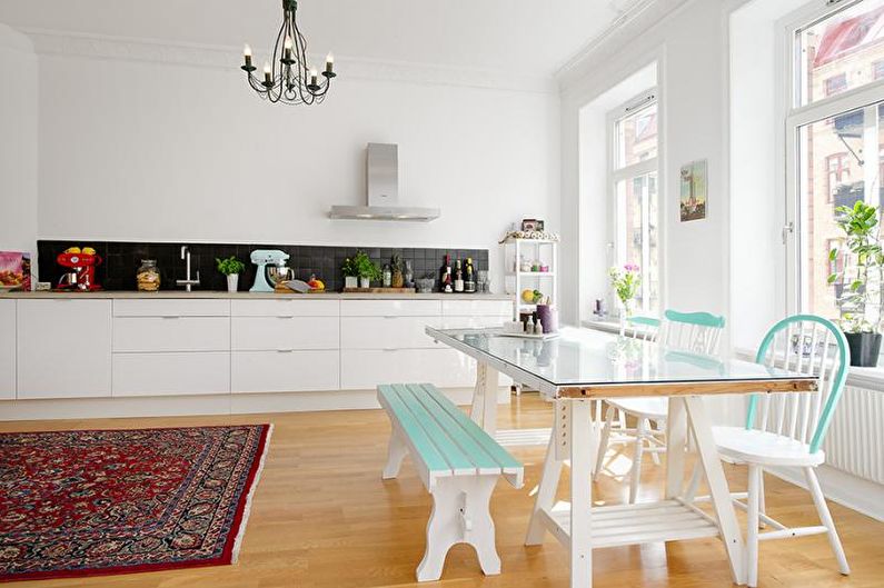 a kitchen with a table and chairs and a rug.