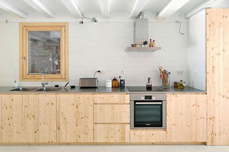 a kitchen with wooden cabinets and a stove.